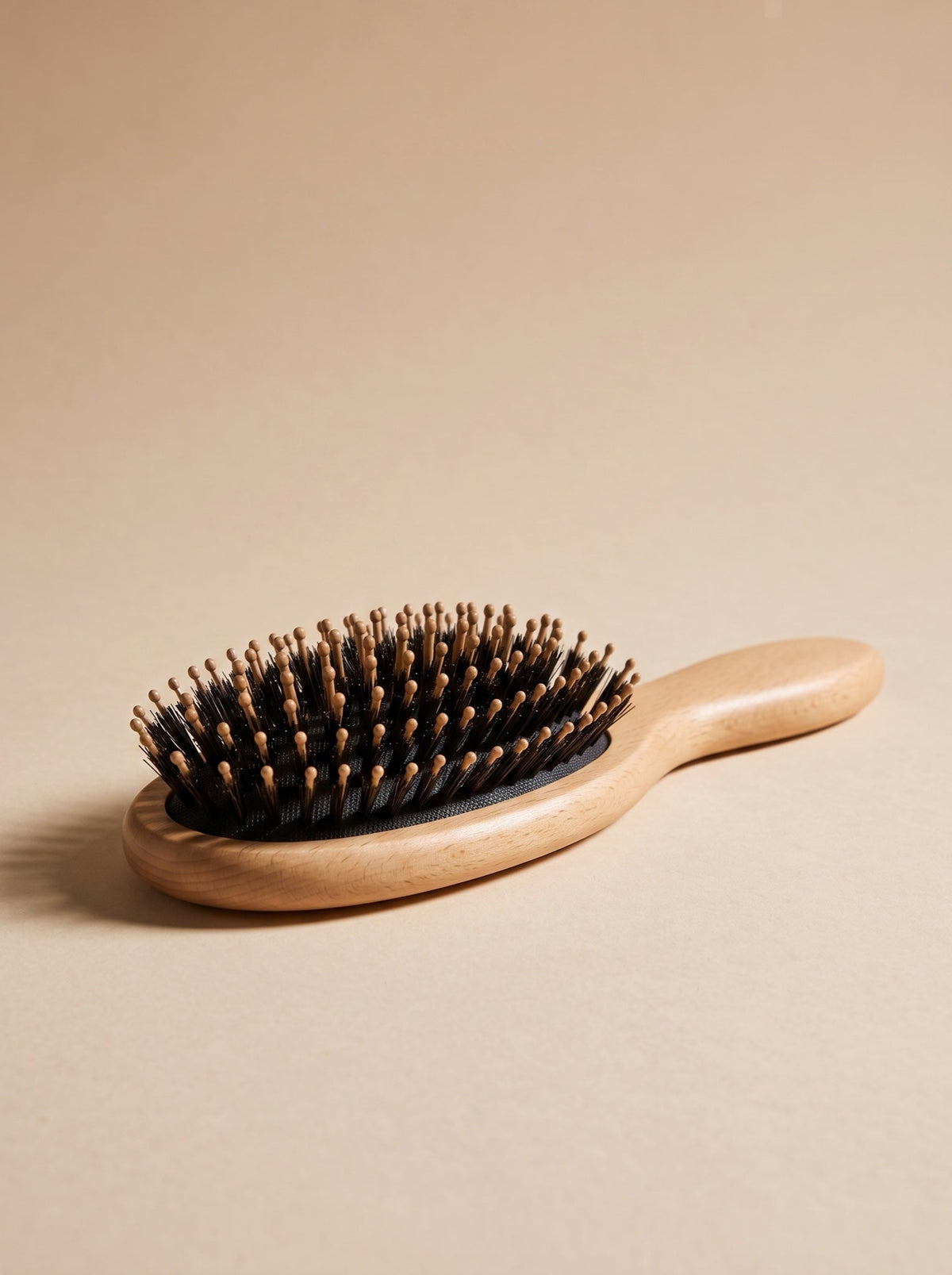 The detangling brush for curly and thick hair on a beige background
